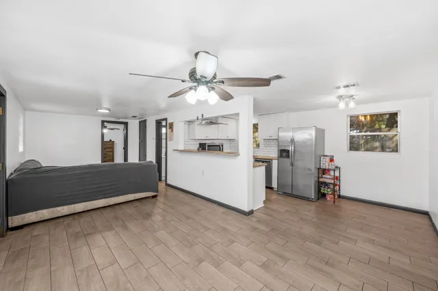 a view of a kitchen with furniture and wooden floor