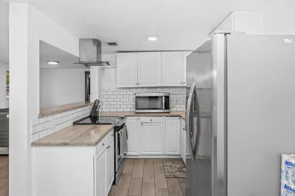 a kitchen with a sink stove and refrigerator