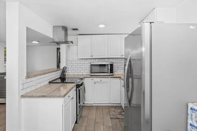 a kitchen with a sink stove and refrigerator