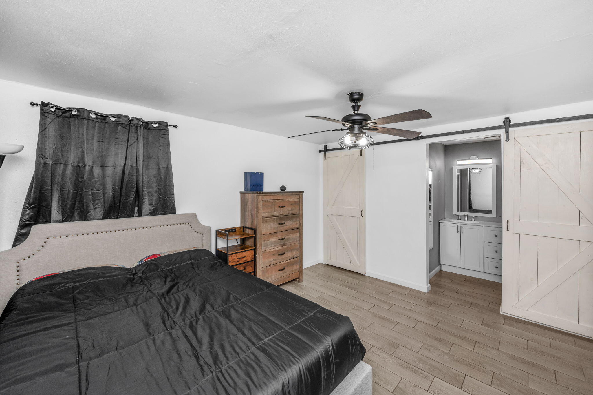 205 Pine Street Fort Walton Beach, FL 32548 - Photo 9 of 20 a bedroom with a bed dresser and a large window