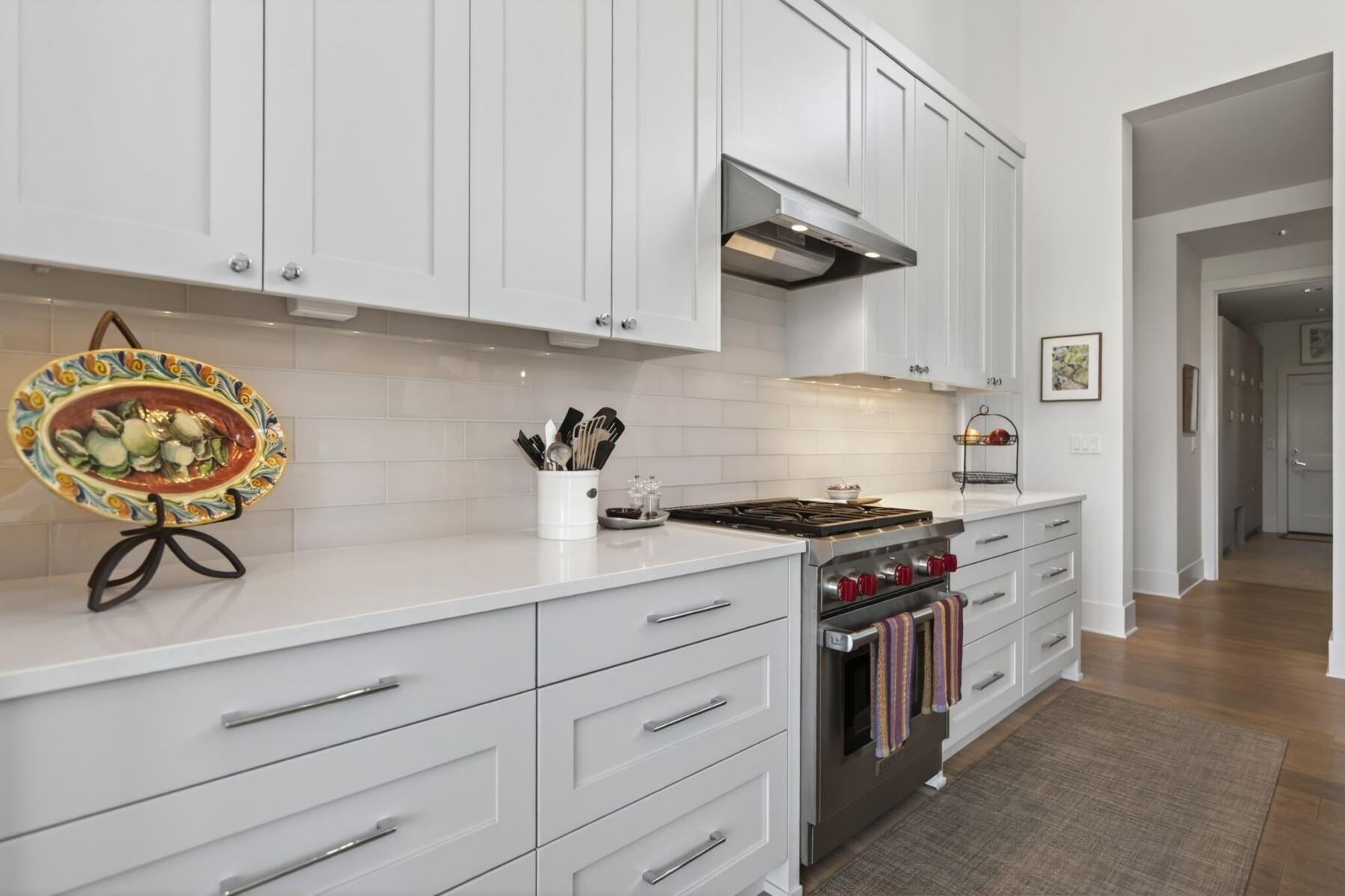 61487 Hackleman Court Bend, OR 97702 - Photo 13 of 35 a kitchen with stainless steel appliances granite countertop white cabinets and a stove top oven