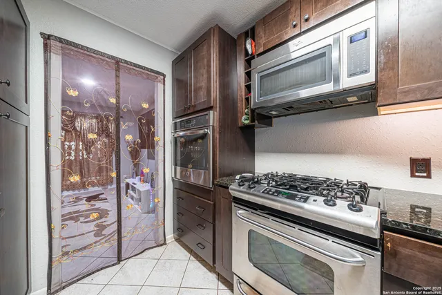 a kitchen with stainless steel appliances granite countertop a stove and a refrigerator