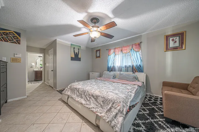 a bedroom with a bed couch and window