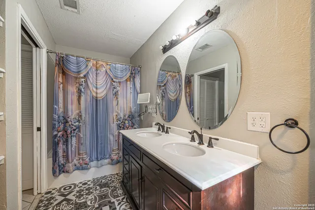 a bathroom with a sink vanity and a mirror