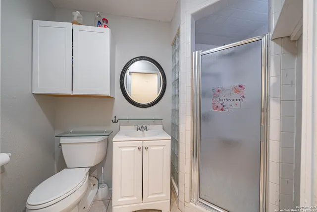 a bathroom with a toilet a sink and a mirror