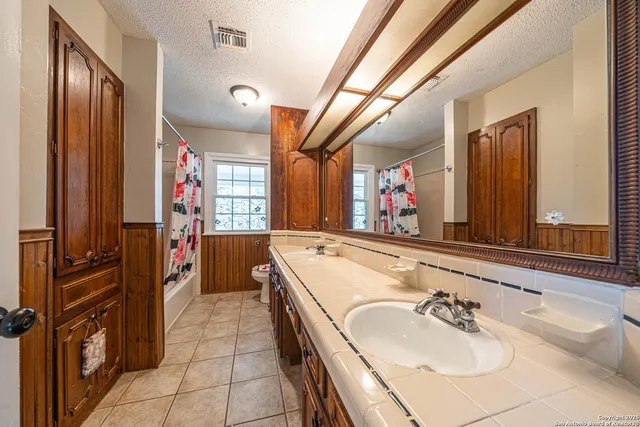 a bathroom with a sink a mirror and a bathtub
