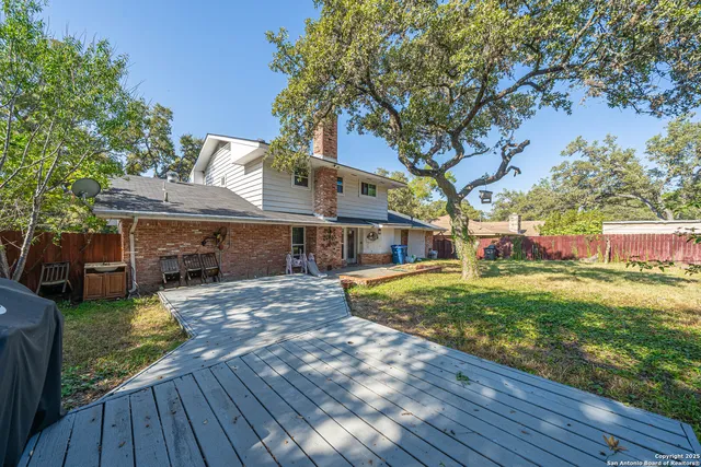 a view of a house with backyard and sitting area
