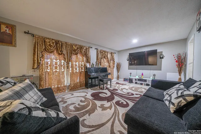 a living room with furniture and a flat screen tv