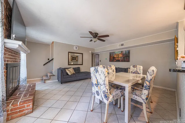 a view of a livingroom with furniture and a ceiling fan