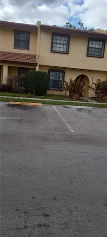 a front view of a house with lots of green space