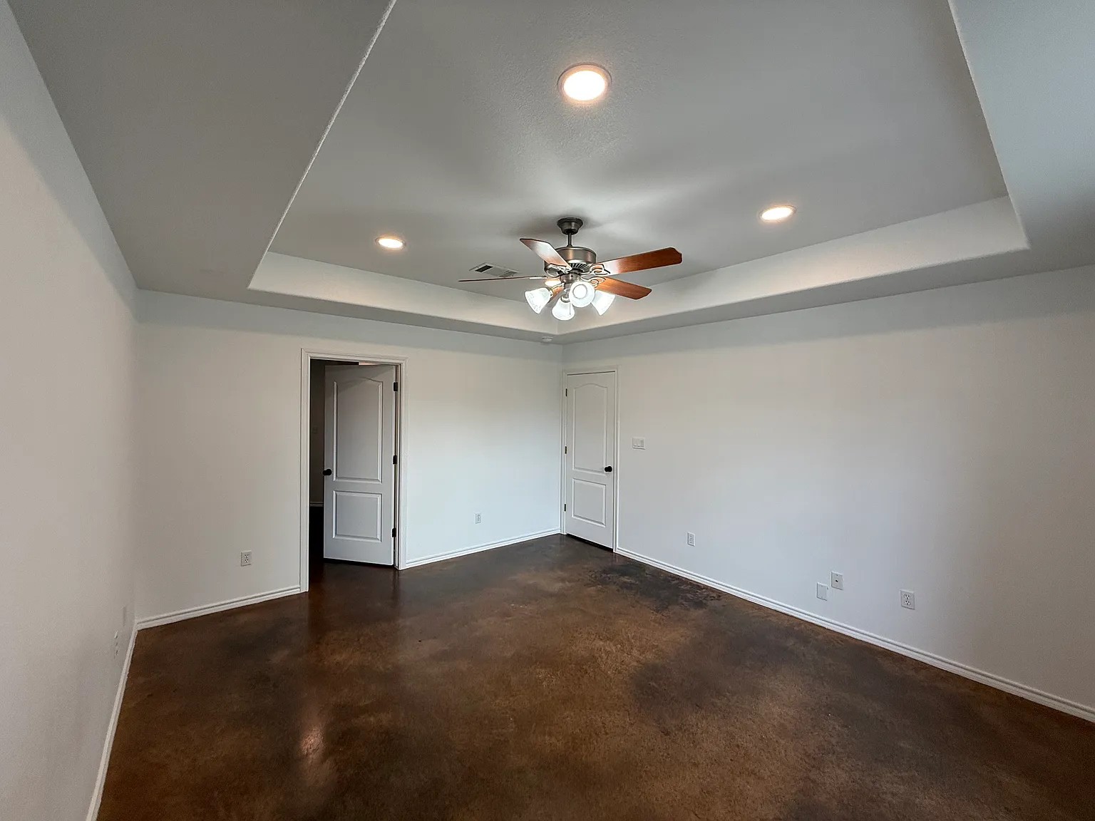 430 Summit Ridge Drive North Point Venture, TX 78645 - Photo 10 of 26 A spacious room features a sophisticated tray ceiling with recessed lighting and a ceiling fan.