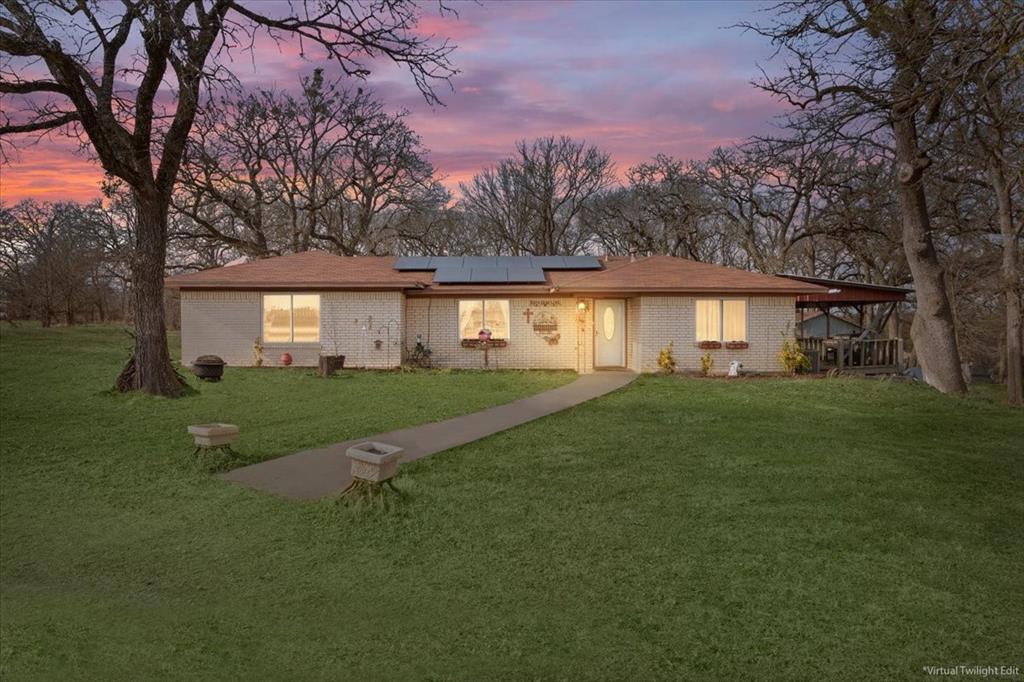 1832 West White Oak Road West, TX 76691 - Photo 1 of 30 a view of house in front of a big yard with large trees