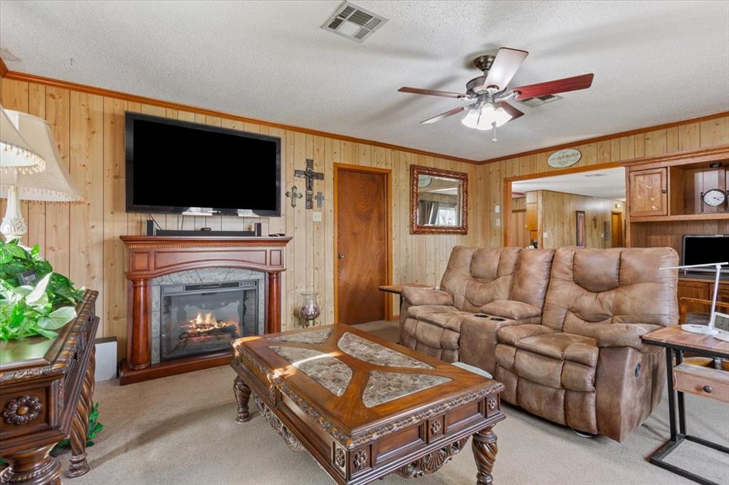 1832 West White Oak Road West, TX 76691 - Photo 11 of 30 a living room with furniture a flat screen tv and a fireplace