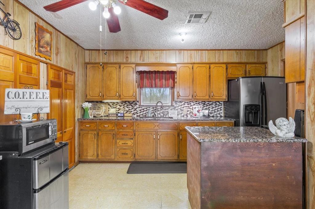 1832 West White Oak Road West, TX 76691 - Photo 14 of 30 a kitchen with stainless steel appliances granite countertop a sink and cabinets