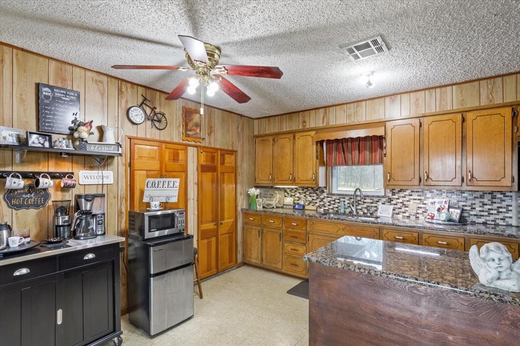 1832 West White Oak Road West, TX 76691 - Photo 15 of 30 a kitchen with stainless steel appliances granite countertop a refrigerator a stove and a sink