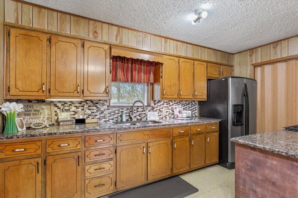 1832 West White Oak Road West, TX 76691 - Photo 16 of 30 a kitchen with stainless steel appliances granite countertop a refrigerator and a sink