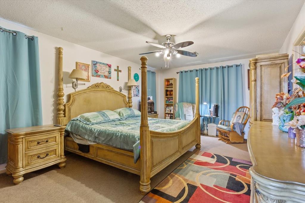 1832 West White Oak Road West, TX 76691 - Photo 17 of 30 a bedroom with a bed and a mirror on the dresser
