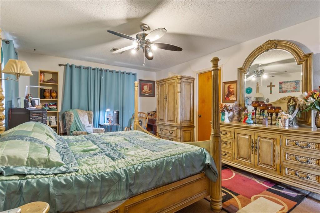 1832 West White Oak Road West, TX 76691 - Photo 18 of 30 a bedroom with a bed and wooden floor