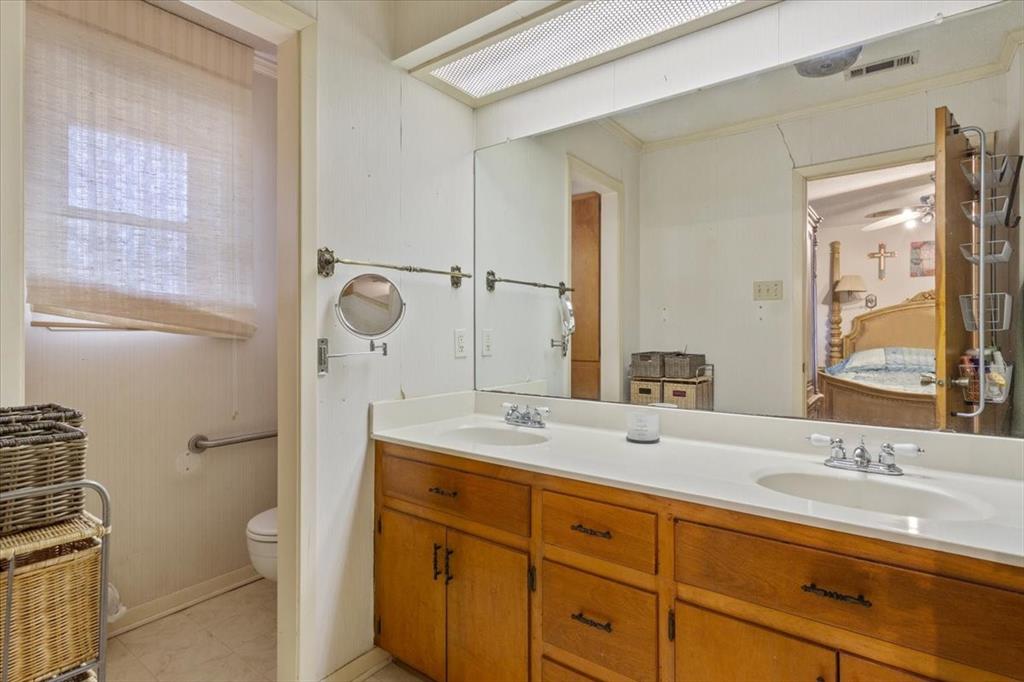 1832 West White Oak Road West, TX 76691 - Photo 20 of 30 a bathroom with a granite countertop sink toilet and shower