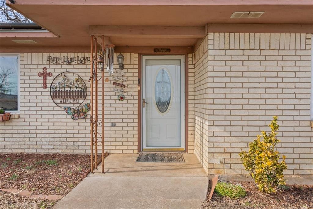 1832 West White Oak Road West, TX 76691 - Photo 8 of 30 a front view of a house with a garden