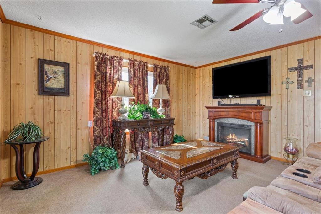 1832 West White Oak Road West, TX 76691 - Photo 10 of 30 a living room with furniture a flat screen tv and a fireplace