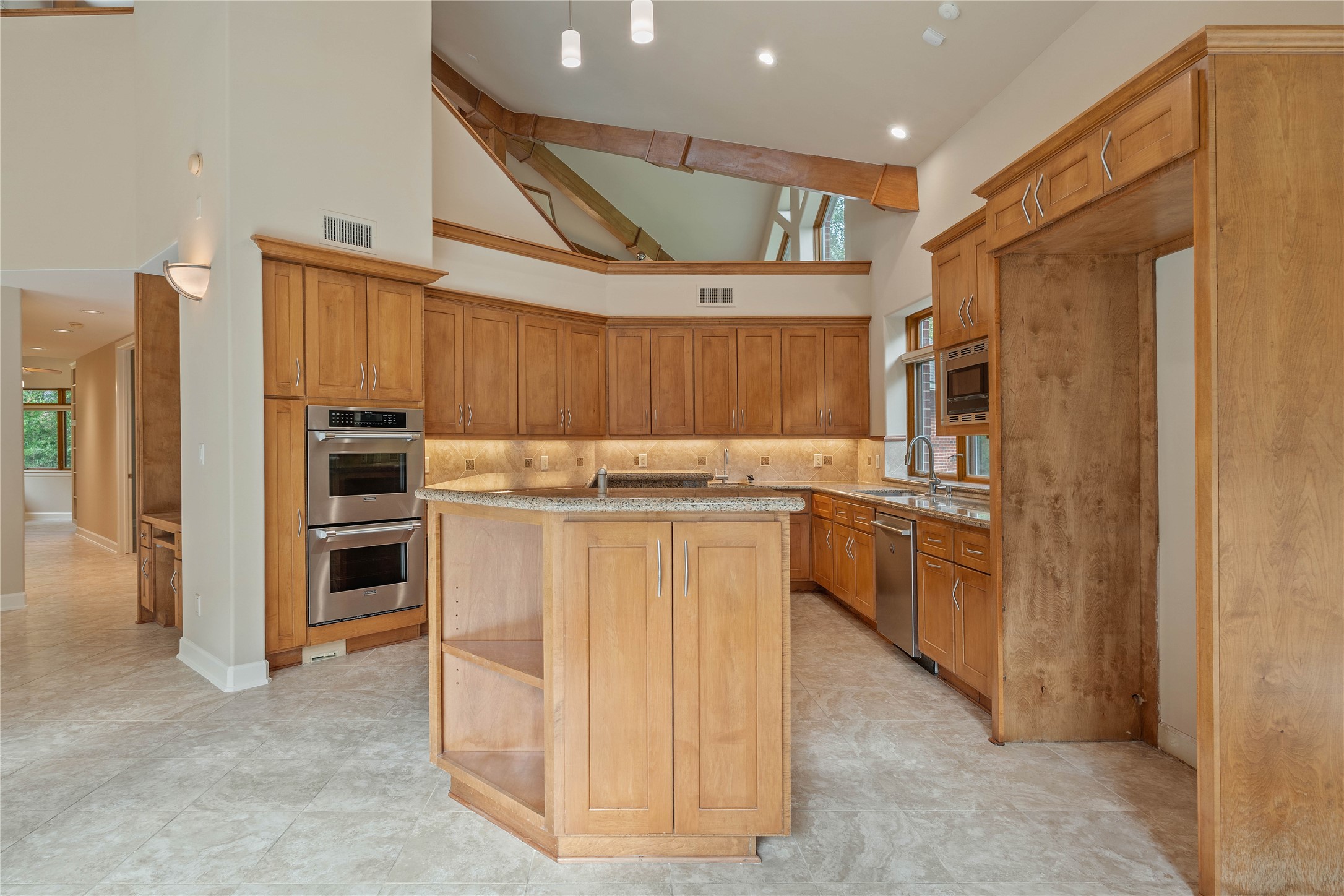 16621 Hereford Road Tomball, TX 77377 - Photo 11 of 46 The kitchen boasts elegant wooden cabinetry, modern stainless steel appliances, and a central island. This warm and inviting space is perfect for culinary creativity.