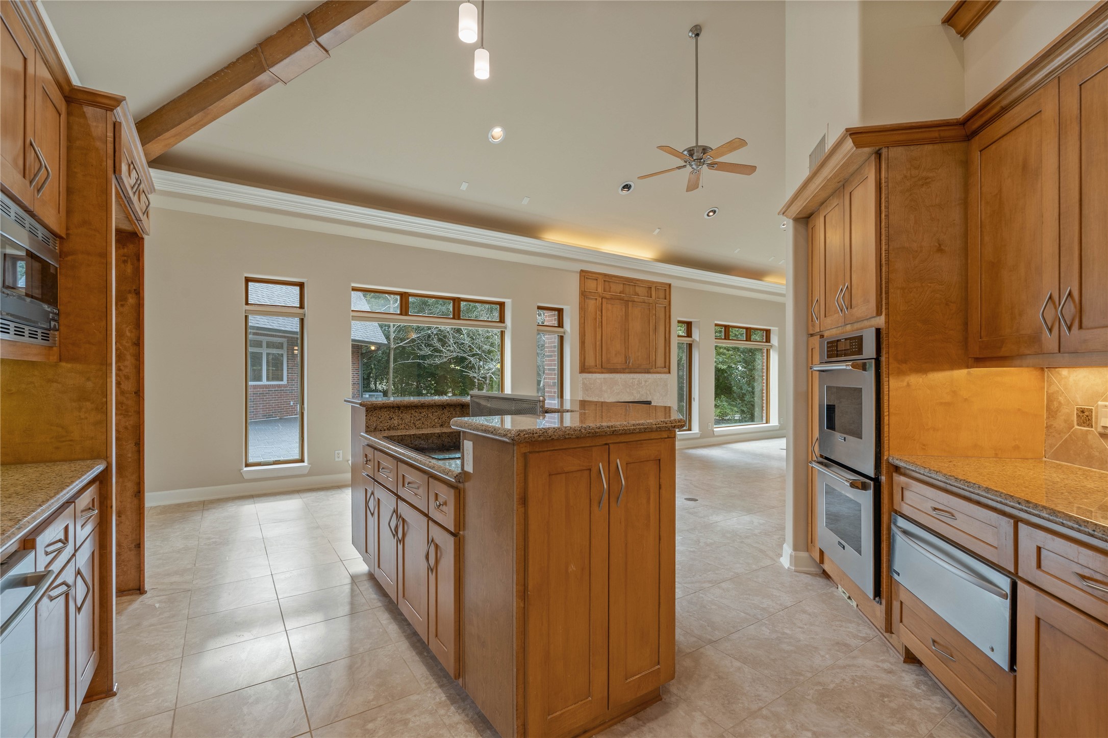 16621 Hereford Road Tomball, TX 77377 - Photo 15 of 46 The heart of the home boasts elegant wooden cabinetry, modern appliances, and an open layout that seamlessly connects to the living area, perfect for entertaining and everyday living.