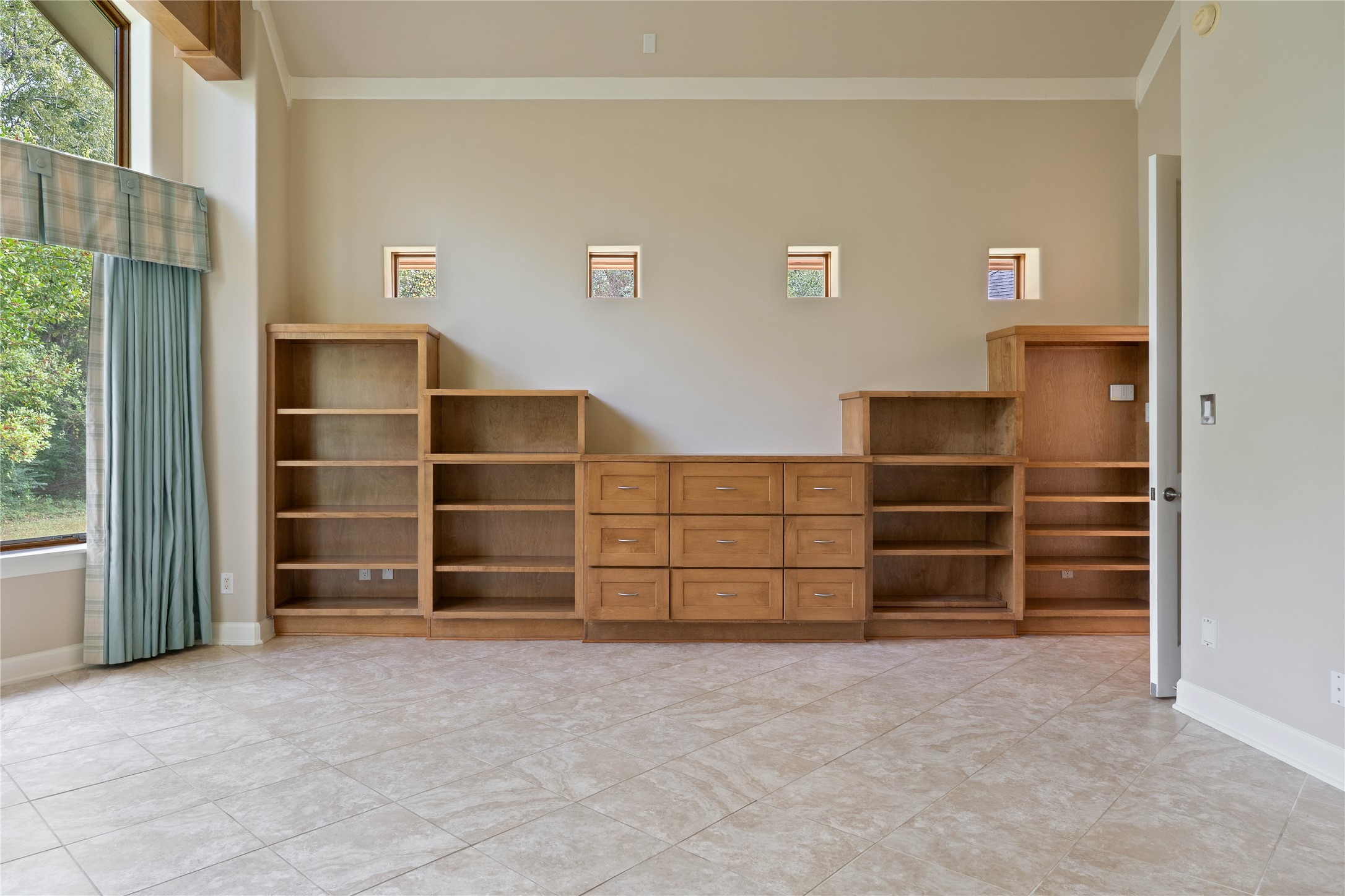16621 Hereford Road Tomball, TX 77377 - Photo 20 of 46 The ultimate blend of style and functionality in the primary bedroom, featuring extensive built-in cabinets and shelves perfect for all your storage needs.