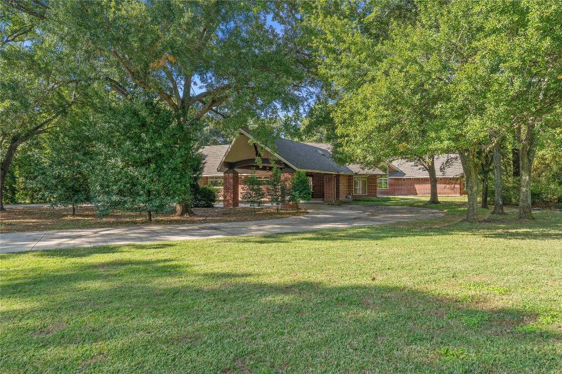 16621 Hereford Road Tomball, TX 77377 - Photo 2 of 46 a house view with swimming pool in front of it