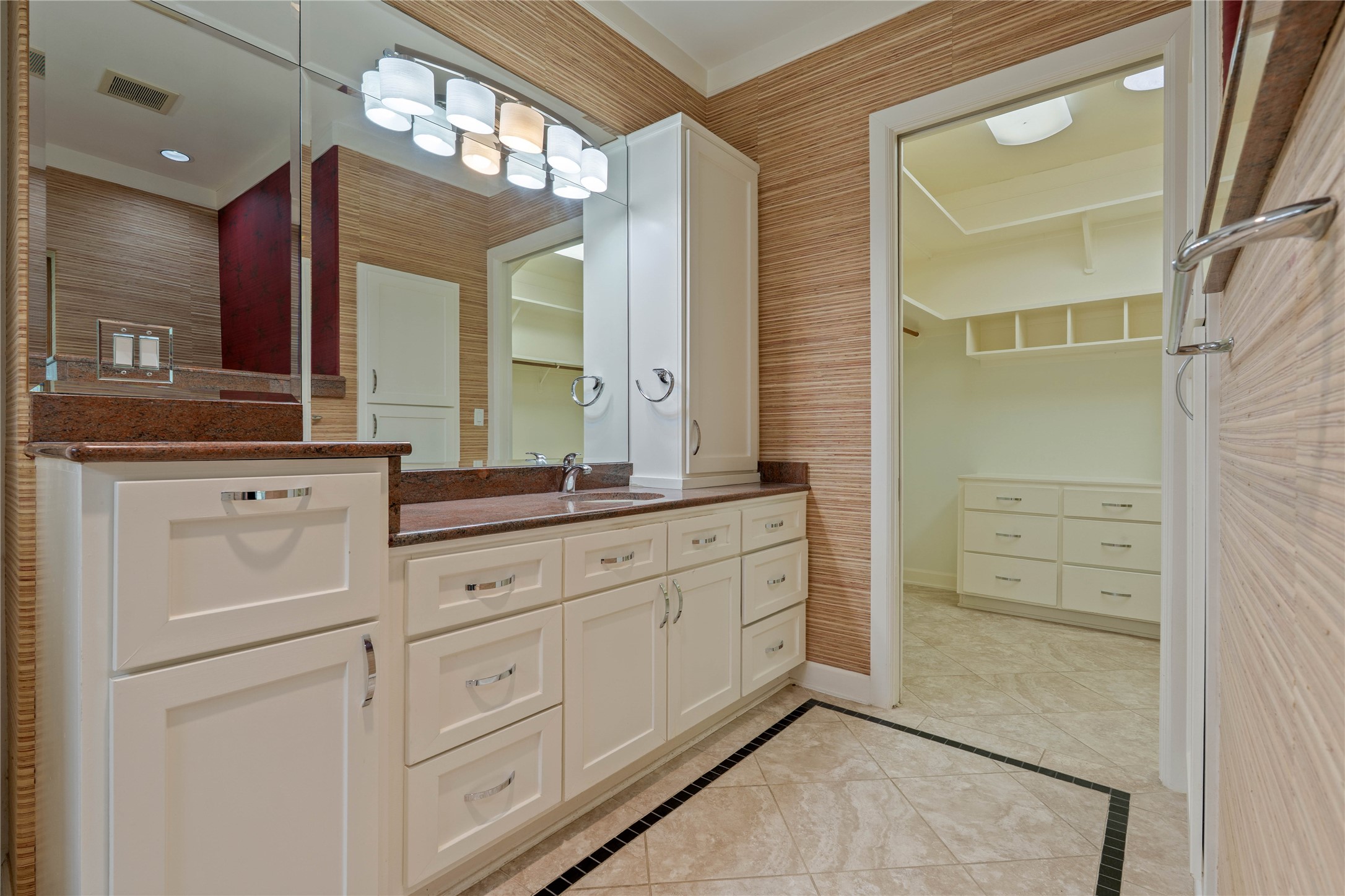 16621 Hereford Road Tomball, TX 77377 - Photo 24 of 46 This elegant primary bathroom seamlessly flows into a spacious walk-in closet, offering both luxury and convenience with ample storage and tasteful design.