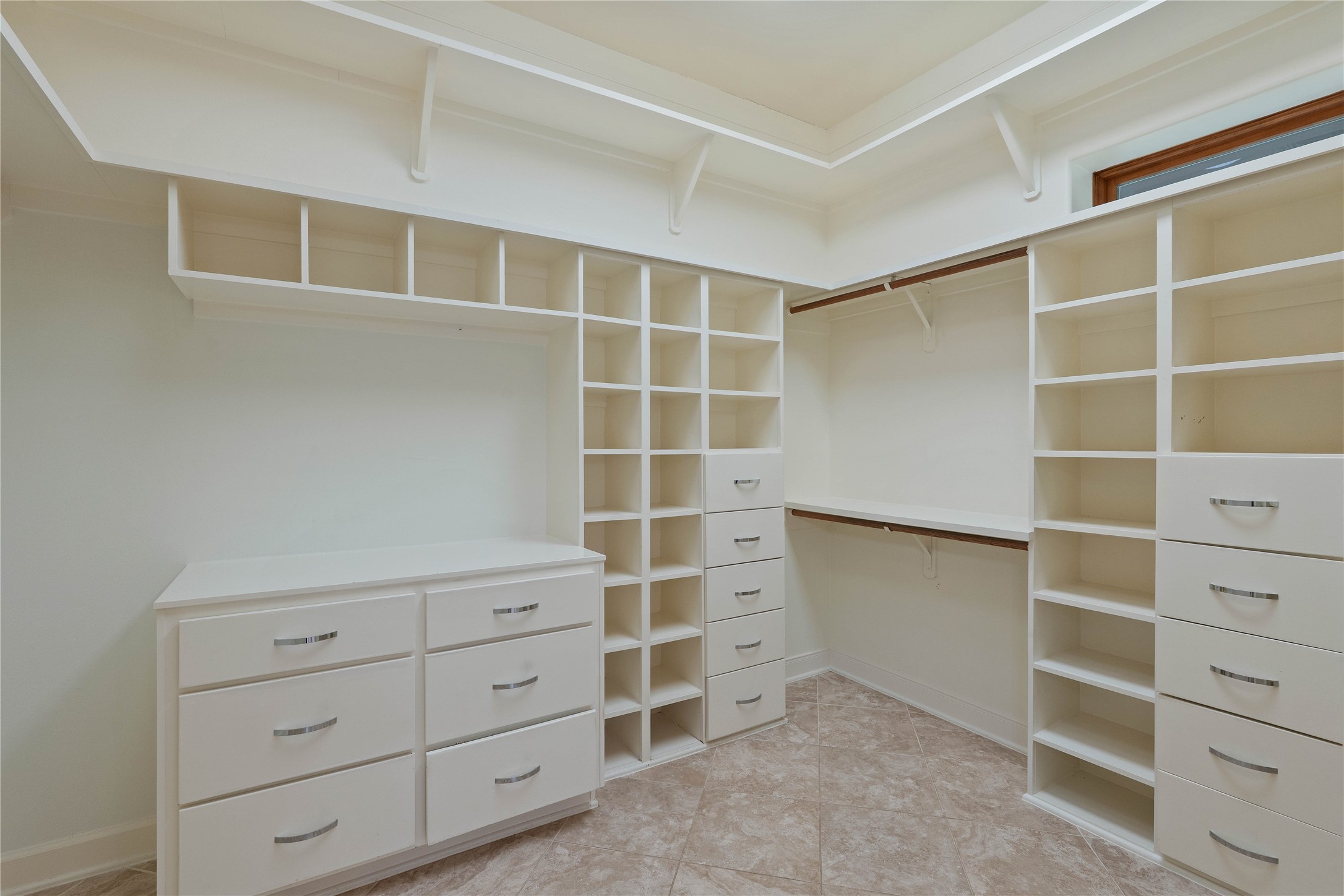 16621 Hereford Road Tomball, TX 77377 - Photo 25 of 46 Ultimate organization in this spacious primary closet, featuring sleek built-in shelving and ample storage to elegantly house your wardrobe.