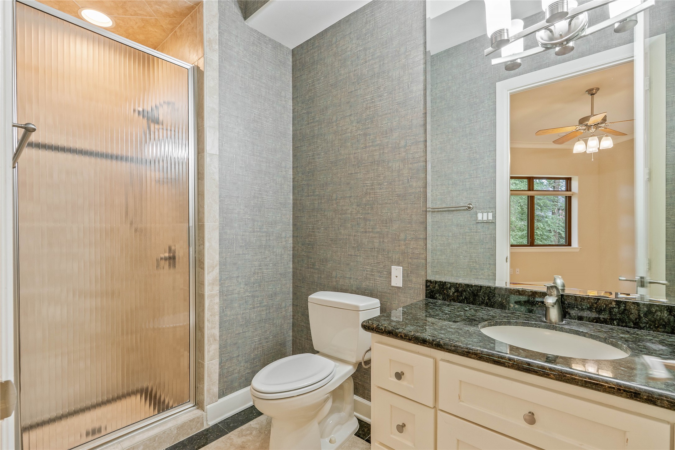 16621 Hereford Road Tomball, TX 77377 - Photo 27 of 46 Bathroom features a sleek glass-enclosed shower, elegant granite countertops, and a bright, modern design, perfect for a refreshing start to your day.