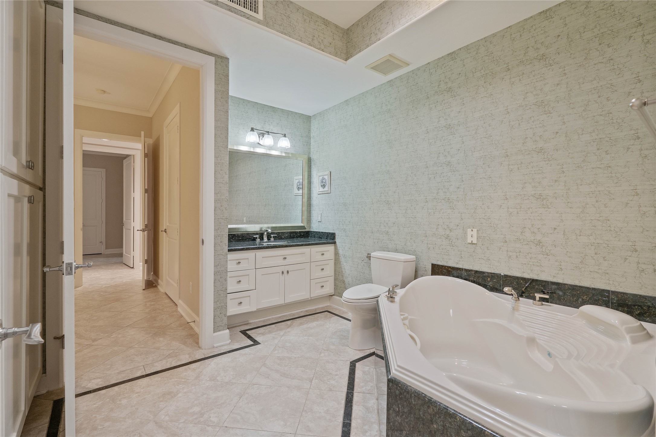 16621 Hereford Road Tomball, TX 77377 - Photo 29 of 46 This bathroom offers a luxurious retreat with its spacious tub, sleek vanity, and stylish finishes.