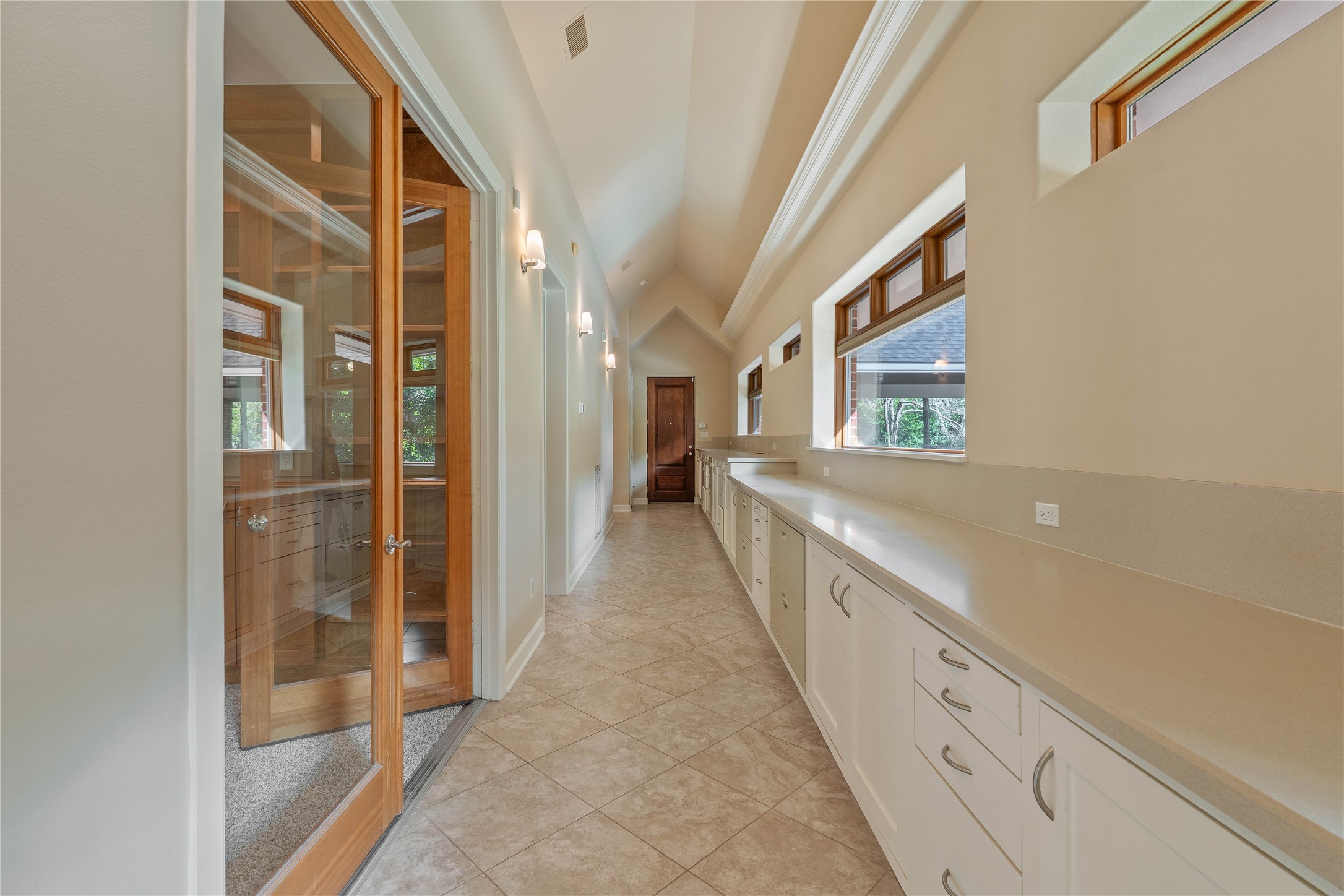16621 Hereford Road Tomball, TX 77377 - Photo 34 of 46 Office hallway offering abundant storage with sleek cabinets and ample filing space, perfect for keeping your work life organized and efficient.