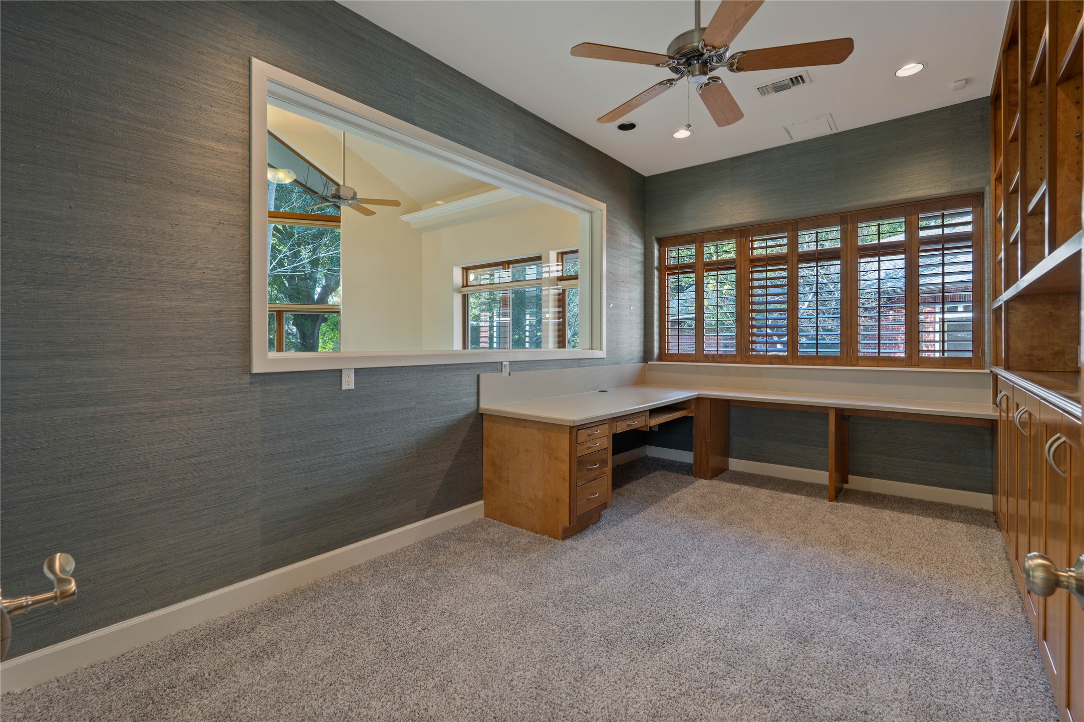 16621 Hereford Road Tomball, TX 77377 - Photo 36 of 46 The "Other Office," a warm and inviting workspace featuring rich wooden cabinetry, abundant natural light, large window looking into the conference room and new carpet.