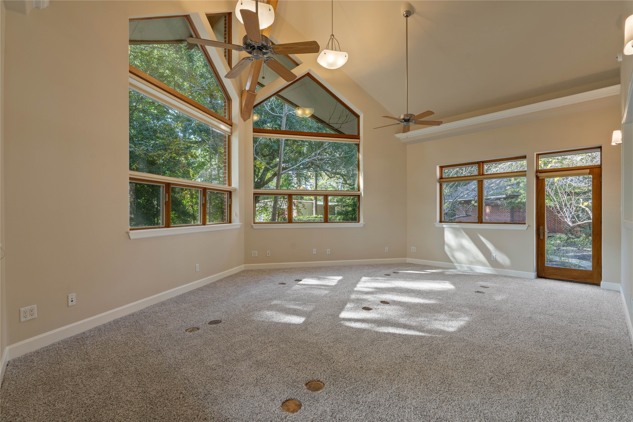 16621 Hereford Road Tomball, TX 77377 - Photo 37 of 46 This spacious conference room features soaring ceilings, abundant natural light from large windows, and elegant ceiling fans, creating an inspiring and versatile space for meetings or creative endeavors.