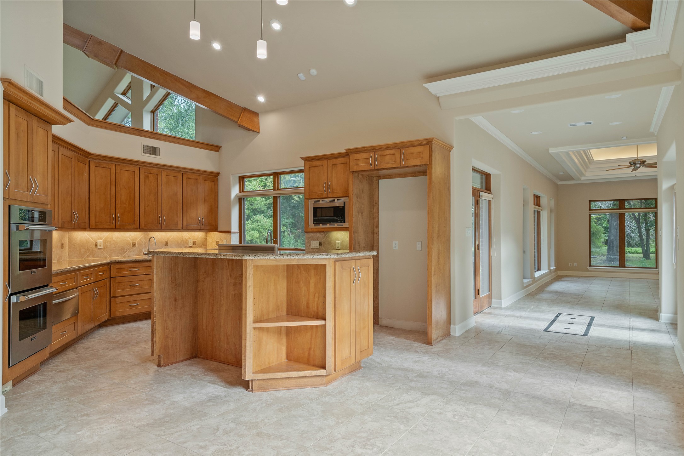 16621 Hereford Road Tomball, TX 77377 - Photo 7 of 46 Experience seamless living in this open-concept space. The elegant kitchen flows effortlessly into the bright and spacious family room.