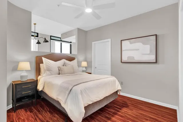 a bedroom with a bed and a wooden floor