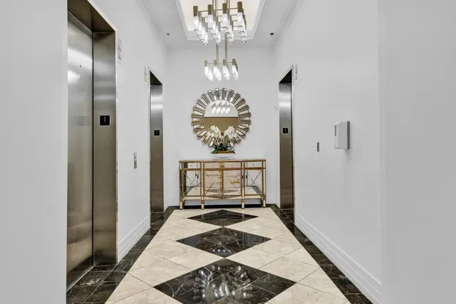 a living room with furniture wooden floor and a chandelier