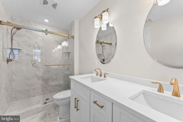 a bathroom with a sink a toilet and a mirror