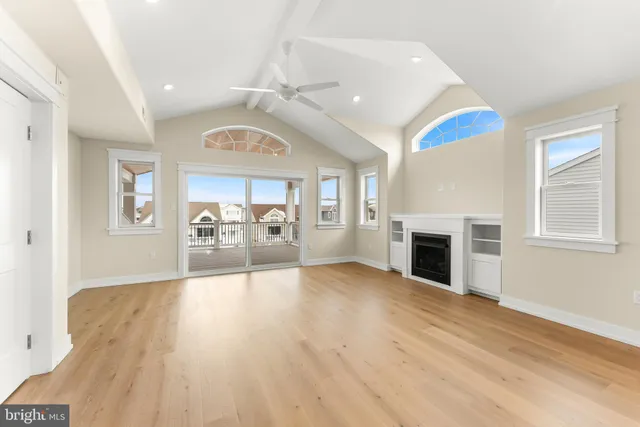 a view of a livingroom with a furniture fireplace and wooden floor