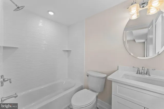a bathroom with a granite countertop toilet a sink and bathtub