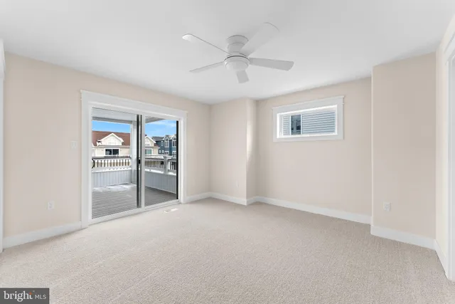 an empty room with fan and windows