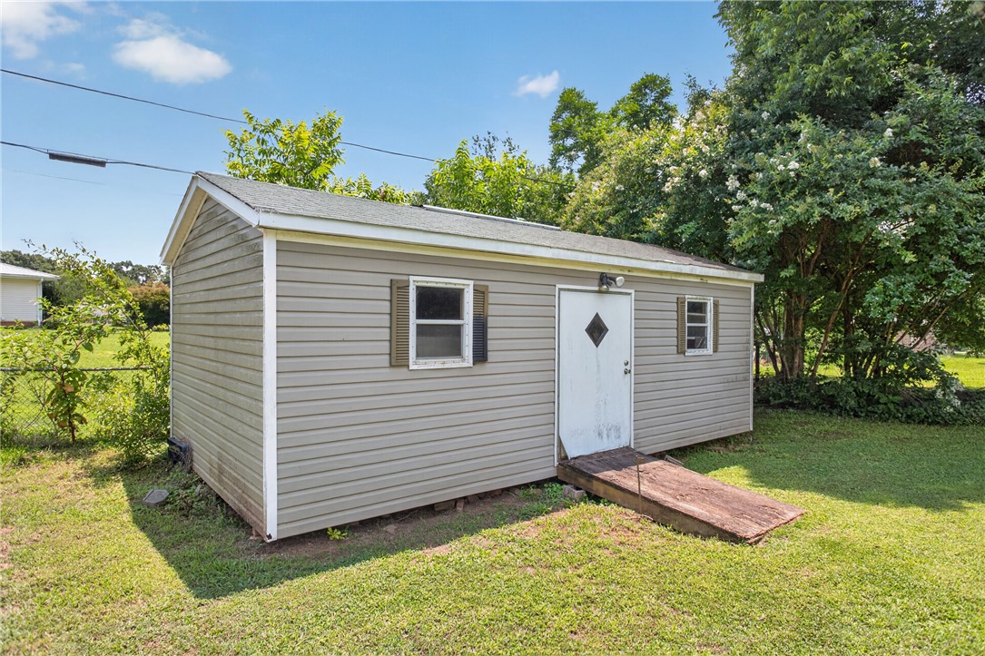 113 Greenfield Avenue Pendleton, SC 29670 - Photo 30 of 40 A quaint utility structure in the yard, offering practical outdoor storage.