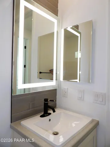 a bathroom with a sink and a mirror