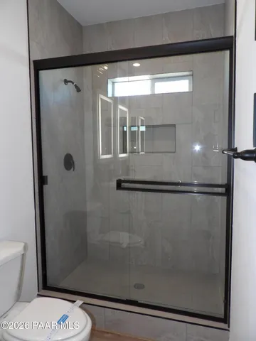a bathroom with a shower and a toilet