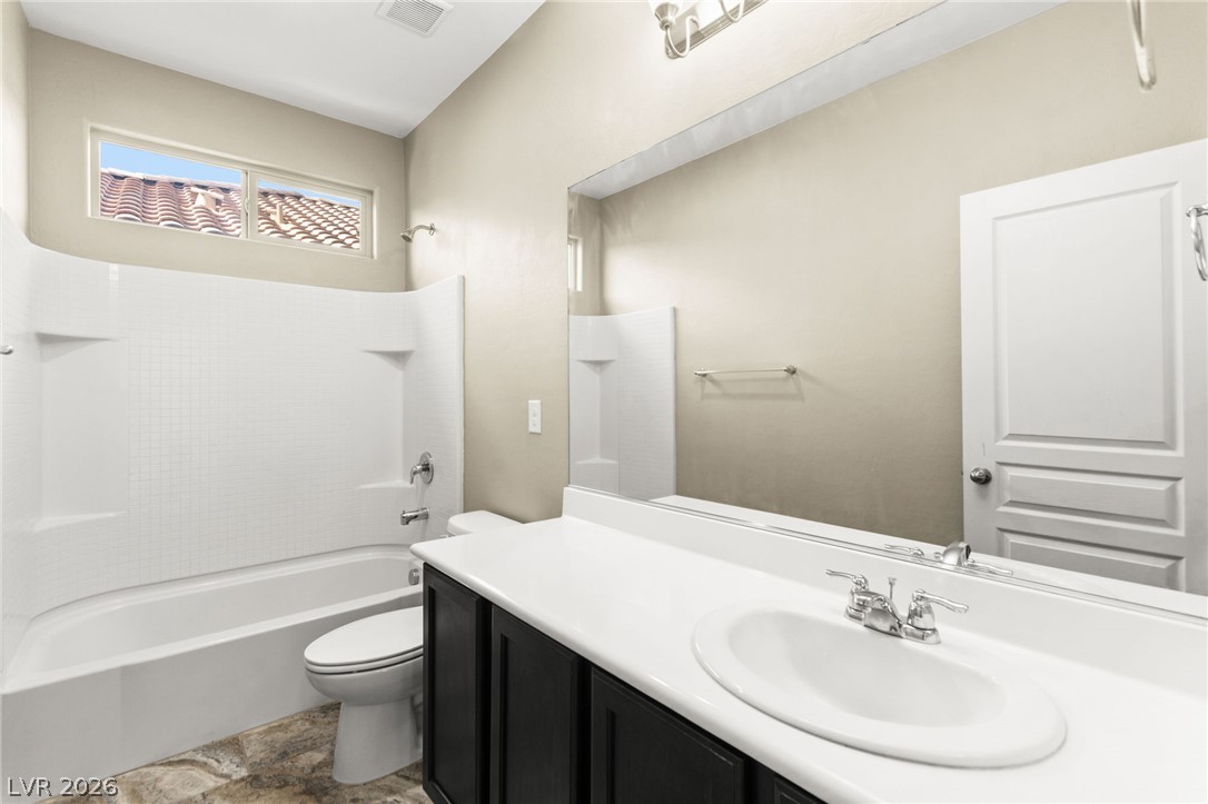 11048 Prairie Grove Road Las Vegas, NV 89179 - Photo 54 of 75 A full bathroom offers a convenient bathtub with an overhead shower and a single vanity with a large mirror.