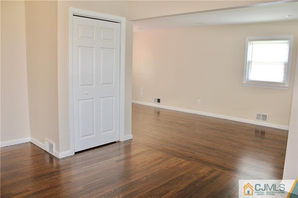 15 Roberts Road New Brunswick, NJ 08901 - Photo 6 of 25 a view of an empty room with wooden floor and a window