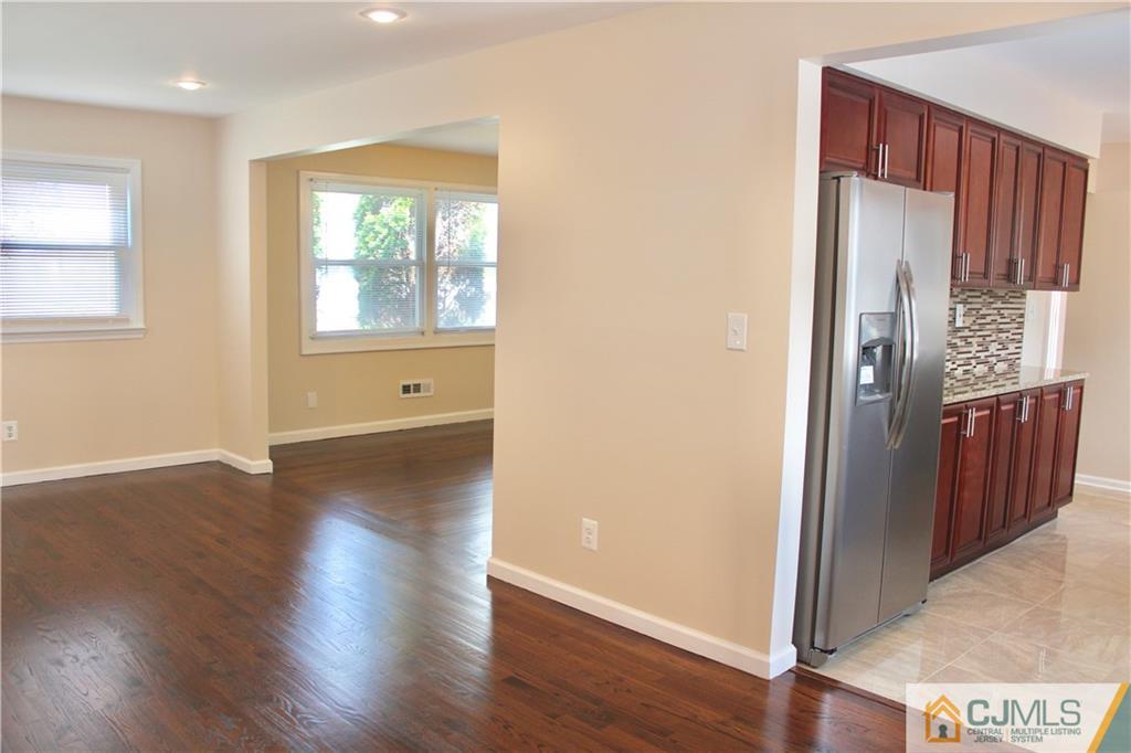 15 Roberts Road New Brunswick, NJ 08901 - Photo 8 of 25 a view of a hallway with wooden floor and windows
