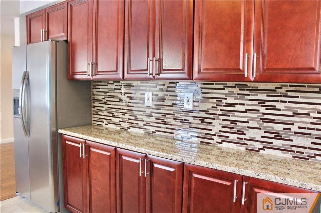 15 Roberts Road New Brunswick, NJ 08901 - Photo 10 of 25 a kitchen with stainless steel appliances granite countertop a refrigerator a sink and dishwasher